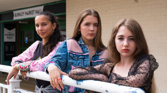 Young people modelling in the 2023 ReFashion Challenge in Burnley Market